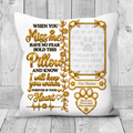 A square white pet memorial throw pillow with gold and black printed text, floral vine graphics, a photo frame placeholder, and a heart-shaped pet name badge, shown against a light gray wood plank background.