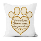 A square white throw pillow featuring a gold and beige paw print design with a heart-shaped center containing the text 'Forever loved Forever missed Always remembered' and a small gold heart.