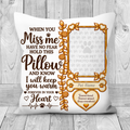 A white pet memorial throw pillow with brown and gold printed text and a photo frame design, displayed against a light gray wood plank background.