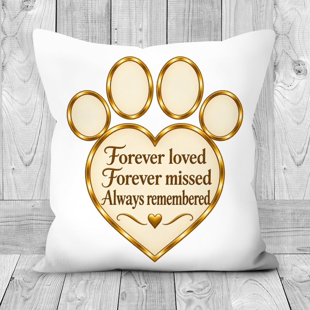 A square white throw pillow with a printed gold and beige paw print and heart design, featuring the text 'Forever loved Forever missed Always remembered' on a rustic gray wood plank background.