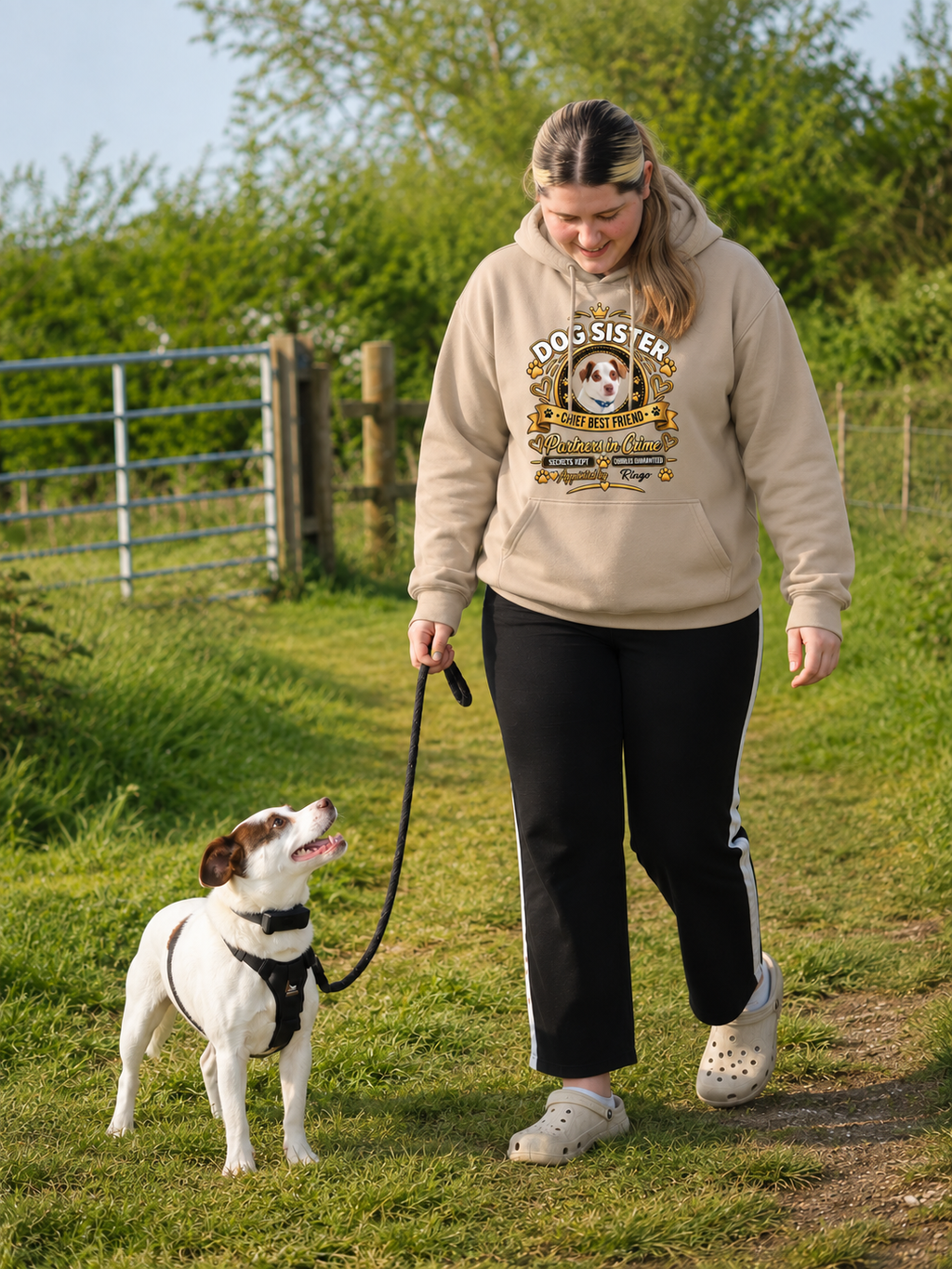 Woman walking her dog wearing a personalised Dog Sister hoodie with custom dog photo and name