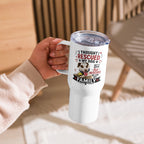 A hand holding a white insulated tumbler with a clear lid. The tumbler features a printed graphic with the text 'I THOUGHT I