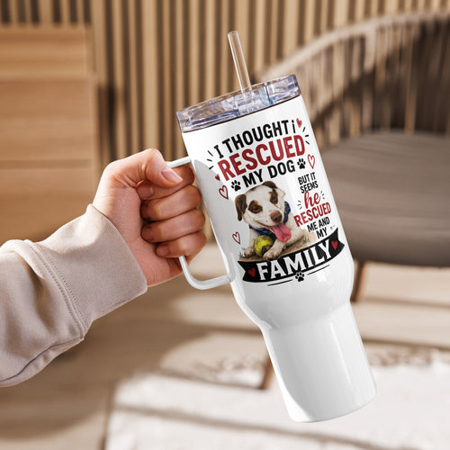 A hand holding a white handled tumbler with a clear lid and straw. The tumbler features a printed design with the text 'I